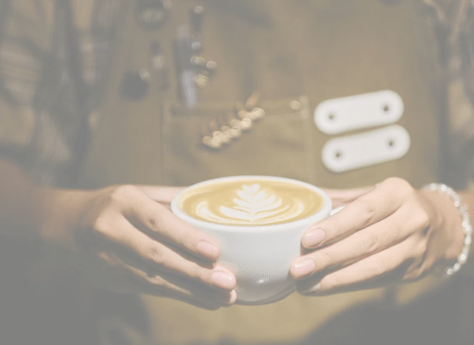 Barista crafting coffee at Café Mystika