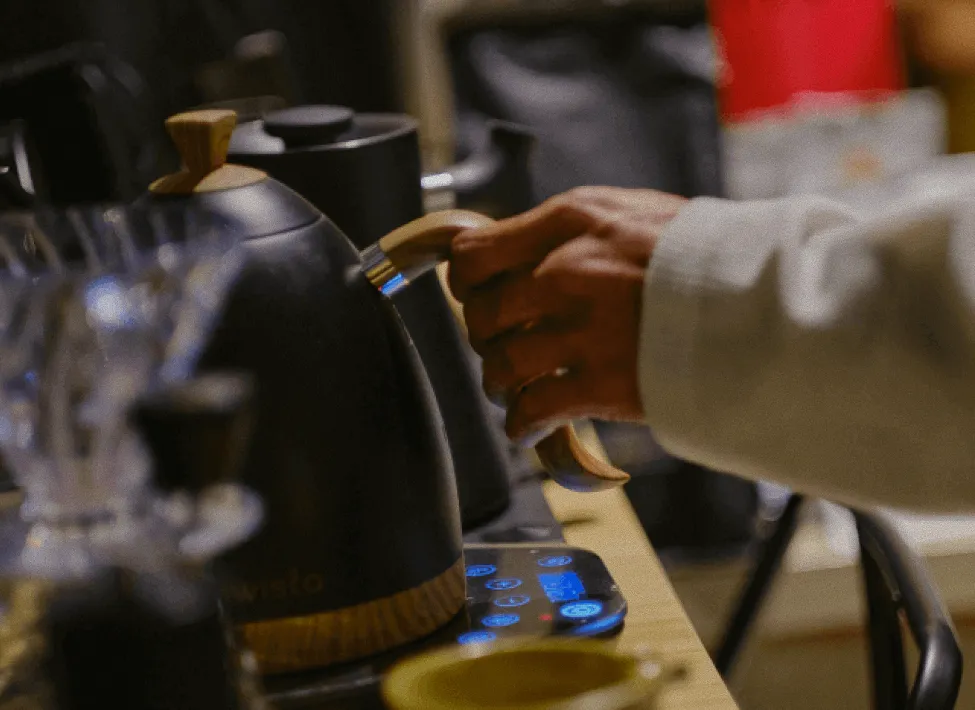 Barista crafting coffee at Café Mystika